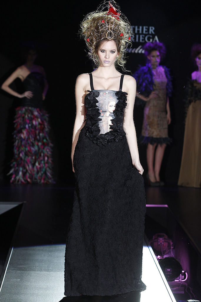 cat walk model dressed in a black long dress with leila ataya's painting across the bodies
